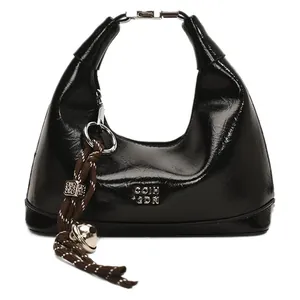 Glossy black hobo bag with metallic closure and decorative woven bell pendant detail