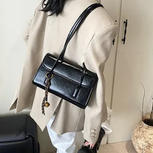 Classic black large capacity underarm bag in glossy leather with bell pendant charm
