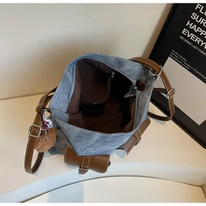 Top view of spacious grey-blue canvas tote bag interior with brown leather trim and pocket