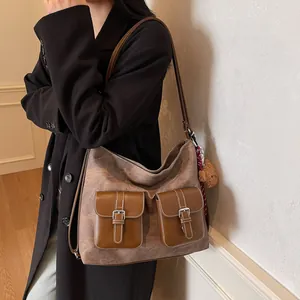 Large vintage brown tote bag with dual front pockets and plush bear charm for daily commute