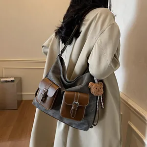 Large grey canvas tote bag with brown leather straps and cute teddy bear pendant charm