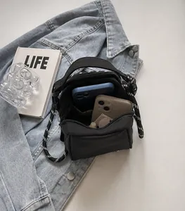 Detail of black canvas crossbody bag interior showing spacious dual phone compartments