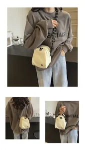 Minimalist nylon crossbody bag detail showing thick cord strap and metal buckle