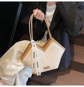 Detail of woven fabric tote bag with leather trim and decorative printed ribbon