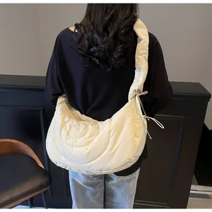 Detailed back view of a beige quilted hobo bag with heart patterns and padded strap