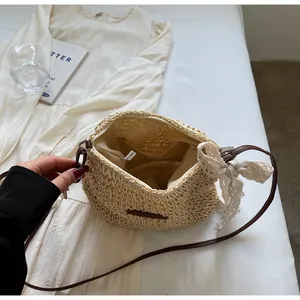 Detail of hand-woven straw bag with lace bow decoration and inner fabric lining