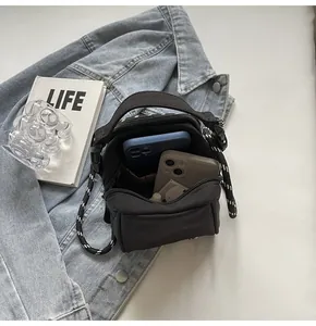 Top view of compact black crossbody bag interior showing capacity for two smartphones