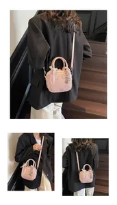 Pink bowling bag detail with lace ribbon bow and heart-shaped metal pendants