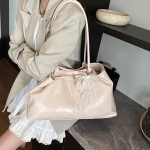 Pink faux leather tote bag with large lace bow charm for daily commuting and leisure
