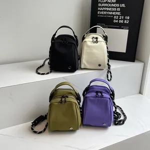 Mini canvas shell-shaped crossbody bags in four colors with textured rope straps