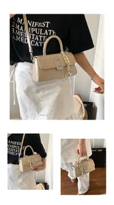 Detail of beige square handbag featuring silver hardware and decorative floral scarf