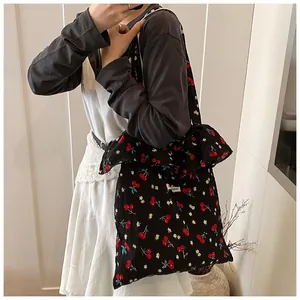 Detail of cherry floral mesh tote bag featuring ruffled edges and delicate fabric texture