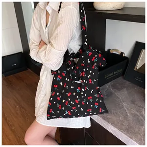 Detail of black cherry floral tote bag with elegant ruffle trim and wide shoulder strap