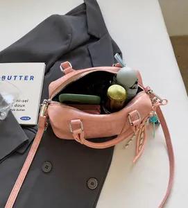 Pink Boston bag showing spacious interior with storage for phone wallet and umbrella