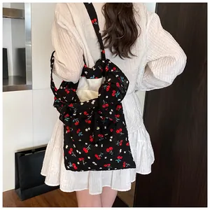 Close-up of mesh cherry floral tote bag with sweet ruffles and wide shoulder strap