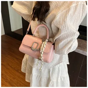 Detail view of pink vintage small square bag with silver buckle and braided rope charm