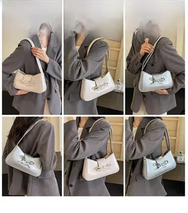 Chic women's underarm bag with bow detail shown on a model in beige and silver colors