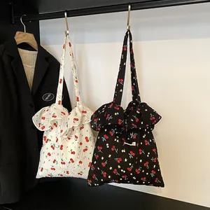 Mesh floral tote bags with cherry patterns and ruffled edges in black and off-white colors