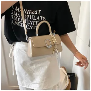 Close-up of beige PU leather handbag featuring square metal buckle and woven rope detail