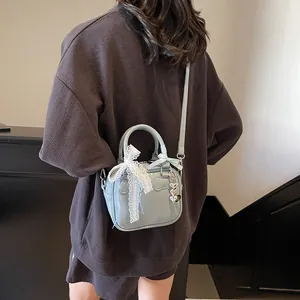 Fashionable light blue bowling bag with lace bow and silver heart charm for women