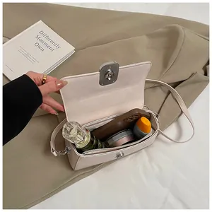 Top view of cream white crossbody bag showing interior space for cosmetics and phone