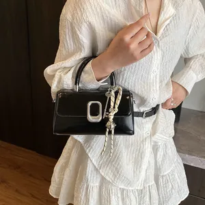 Minimalist black glossy small square handbag with silver metal buckle and woven charm