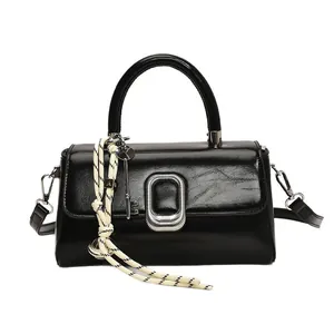 Minimalist black glossy square handbag with silver buckle and braided rope charm detail