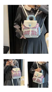 Detail of pink gingham fabric and white leather trim on a mini student backpack