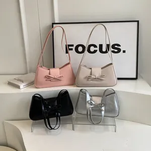 Fashionable minimalist baguette bags in pink, beige, black, and silver with bow detail