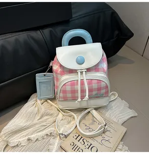 Detail of pink plaid mini backpack with blue handle and matching detachable card holder