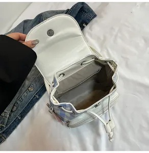Detail view of mini plaid backpack with drawstring closure and magnetic metal buckle
