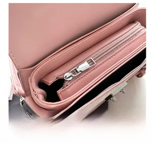 Internal view of pink leather crossbody bag showing smooth silver zipper and compartments