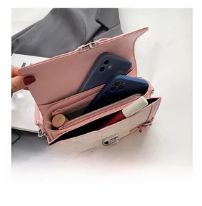 Internal view of the pink crossbody bag showing main compartment and zipper pocket
