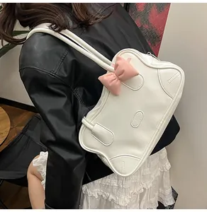 Detailed view of the pink 3D bow and wavy edge on the white PU leather tote bag