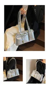 Detail of silver metallic shoulder bag with decorative buckle and mini pouch accessory