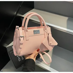 Detail of light pink leather handbag with silver twist lock and matching mini coin purse