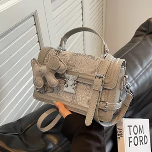 Elegant grey square handbag with traditional embroidery and dog charm, 2025 fashion style
