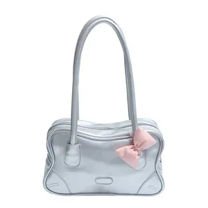 Silver metallic tote bag with pink bow accent and long shoulder straps for women