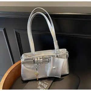Detailed view of silver metallic motorcycle tote bag with buckle straps and mini pouch