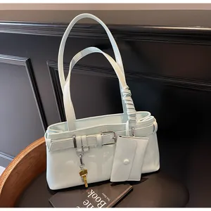 Light mint green shoulder bag detail with belt buckle decor and key-shaped pendant