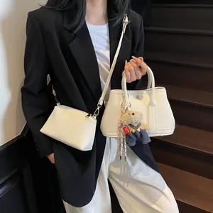 Minimalist white tote bag set with matching crossbody and plush bear charm decoration