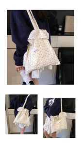 Detail of floral canvas tote bag featuring ruffled edges and Magic Pocket label