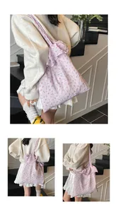 Detail of light purple floral canvas tote with elegant ruffle strap and wrinkled texture