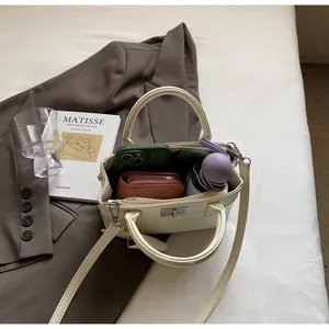 Top-down view of cream leather handbag interior showing storage for phone and accessories