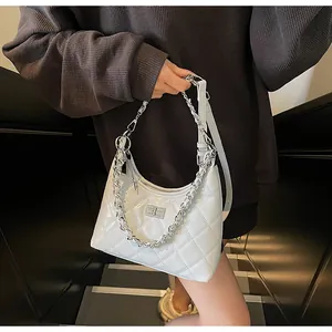 Detailed view of the white quilted leather hobo bag with a silver chain and metal clasp