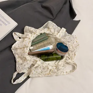 Detail shot showing the large interior capacity of the floral canvas tote bag with daily items