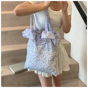 Floral canvas tote bag with pleated ruffles and Magic pocket label held by model
