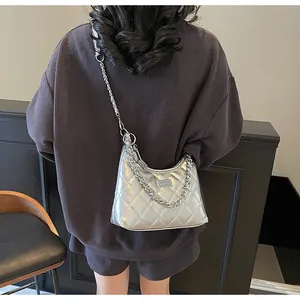 Detailed view of silver quilted crossbody bag with metallic finish and chain strap