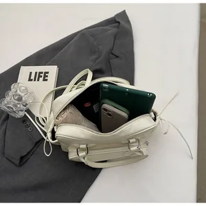 Detail view of large capacity cream pillow bag interior with tablet and umbrella storage