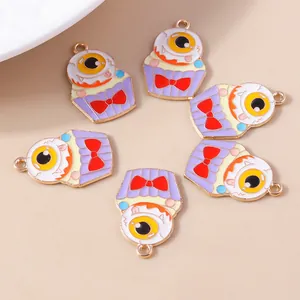 Detailed macro view of six Halloween monster cupcake charms with eyeball and red bow